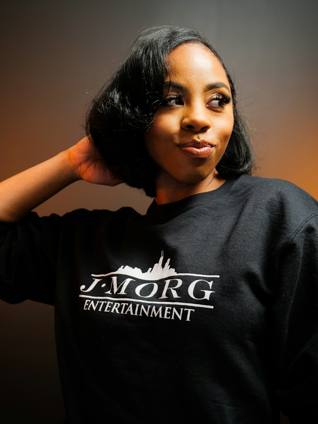 Young woman with short black hair wearing a black sweatshirt.