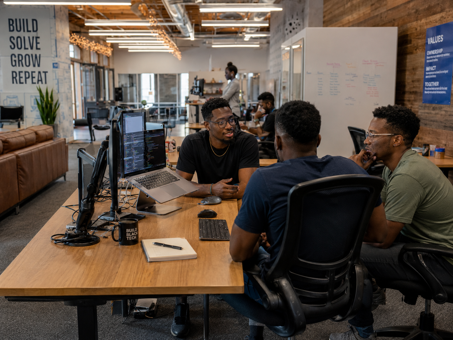 Black founder working at a laptop